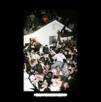 a crowd of people gathered around a house