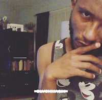 a man wearing a mickey mouse tank top